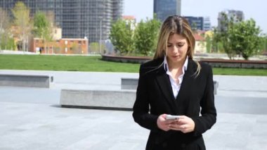 Açık bir smartphone kullanarak gülümseyen iş kadını