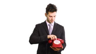 Kırmızı bir vintage telefon tutarak işadamı