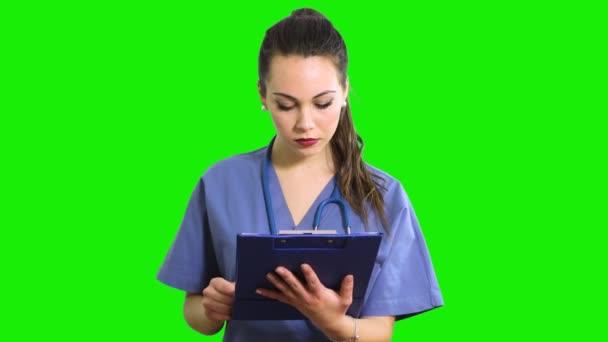 Female Nurse Reading Documents Clipboard — Stock Video
