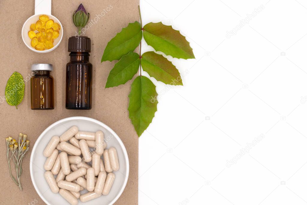 Background with and pills capsules dietary supplements, medicinal oils and herbs, healthy lifestyle and disease treatment, flat lay with blank space, top view