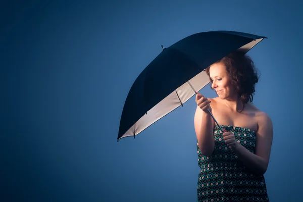 Joyful woman protected by an umbrella on a cold day — Stock Photo, Image