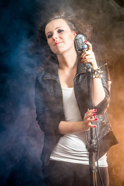 Fog and stage lighting and a young singer — Stock Photo, Image