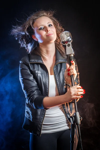 Beautiful young woman as a singer — Stock Photo, Image
