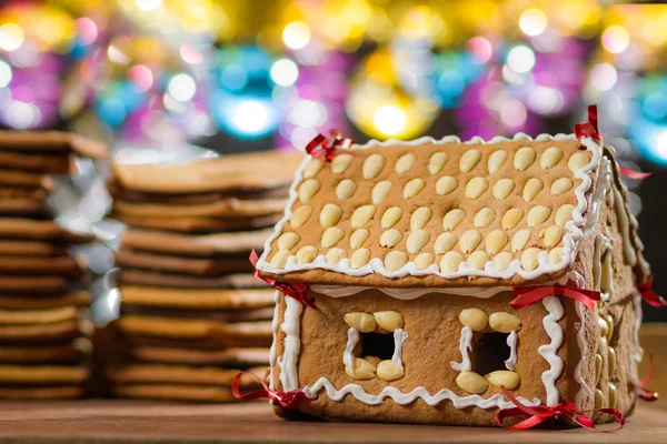 Hausgemachte Lebkuchenhaus am Weihnachtsbaum Lichter Hintergrund — Stockfoto