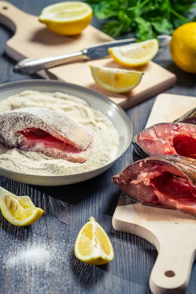 Fresh fish and ingredients for her cooking — Stock Photo, Image