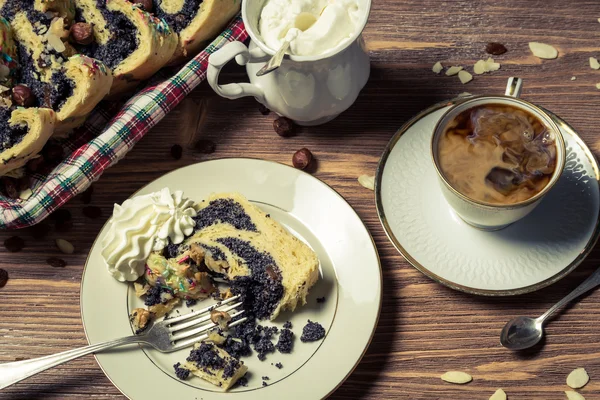 Poppy seed cake and cup of coffee on old table