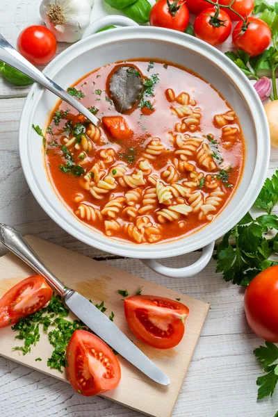 Tomato soup in a vase and fresh tomatoes — Stock Photo, Image