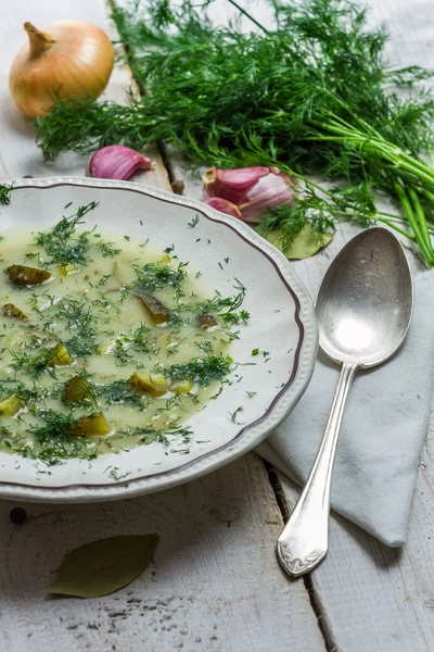 Bowl of soup with dill cucumber on old wooden table — Stock Photo, Image