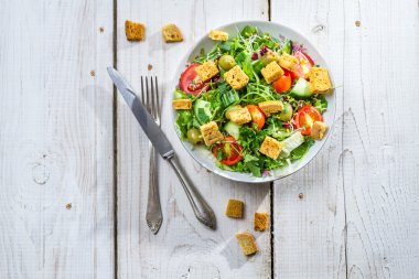 Fresh vegetables salad with croutons and chicken clipart