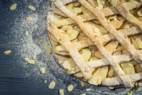 Closeup of apple pie with almonds and icing sugar — Stock Photo, Image