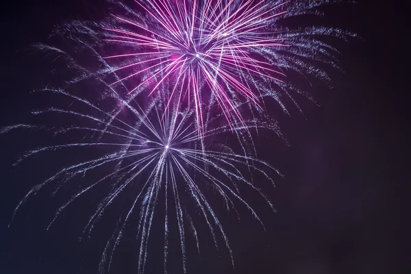 Red and blue fireworks during the celebrations at night — Stock Photo, Image