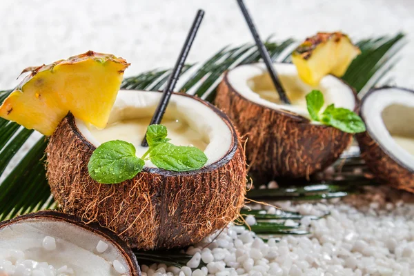 Closeup of pinacolada with mint leaf in the coconut — Stock Photo, Image