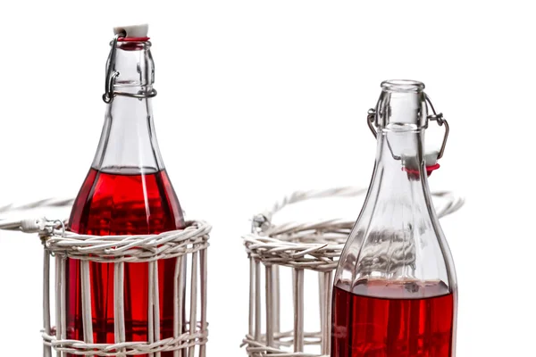 Closeup of red juice in bottles — Stock Photo, Image