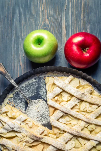 Mele e torta di mele appena sfornata sul vecchio tavolo blu — Foto Stock