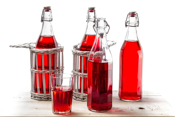 Bottiglie con succo rosso su sfondo bianco — Foto Stock