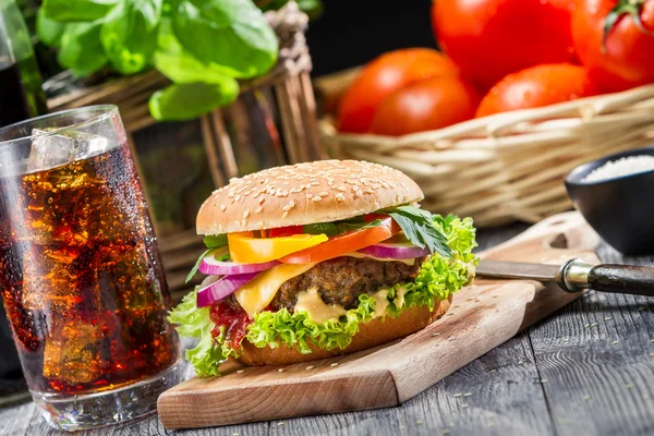 Un gustoso hamburger fatto in casa e una Coca Cola con ghiaccio — Foto Stock