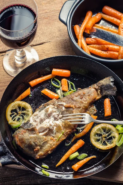 Frischer gebratener Fisch serviert mit Rotwein — Stockfoto