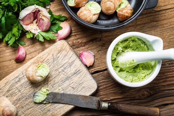 Closeup of filling snails with garlic butter — Stock Photo, Image