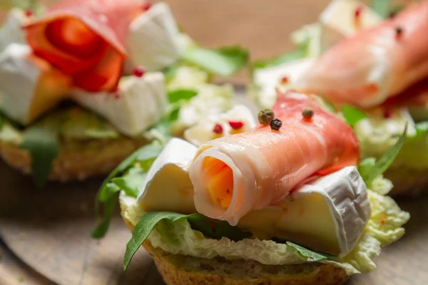 Closeup of fresh sandwiches with parma ham and camembert — Stock Photo, Image