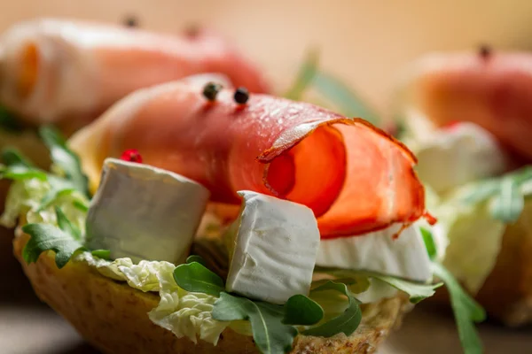 Closeup of sandwiches made of parma ham and brie cheese — Stock Photo, Image