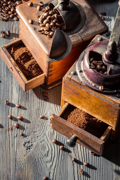 Old coffee grinders with seeds — Stock Photo, Image