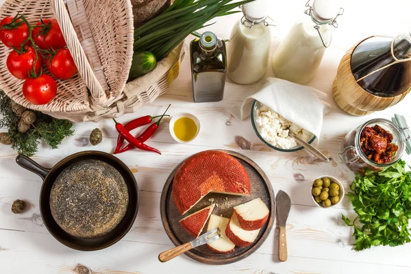 Varios productos frescos y una cesta llena de verduras — Foto de Stock