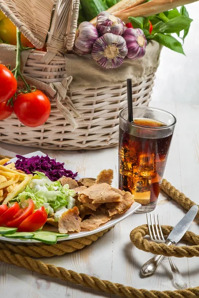 Vegetables and meat kebab served with fries and a Coke — Stock Photo, Image