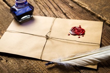 Old feather, envelope, sealing wax and ink bottle clipart