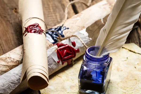 Closeup of ancient scrolls writing by feather with blue ink