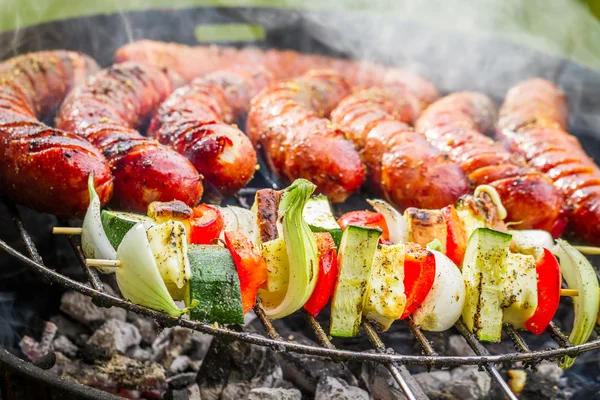 Sausages and skewers on the grill — Stock Photo, Image