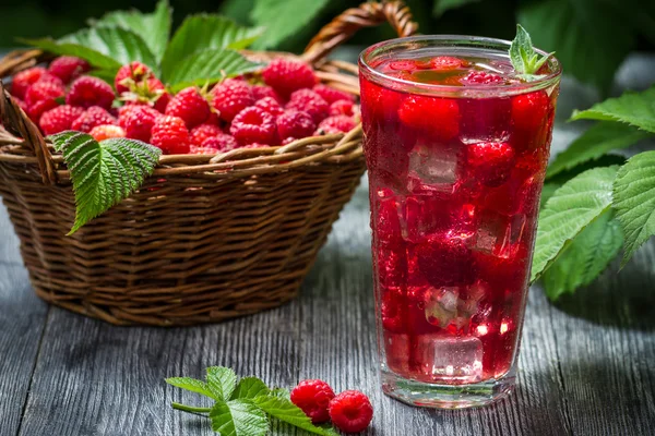 Juice of fresh raspberries served with ice in a glass — Stock Photo, Image