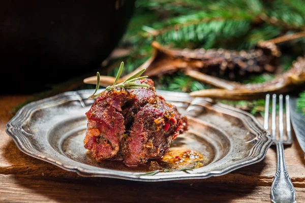 Metal plate with baked venison — Stock Photo, Image