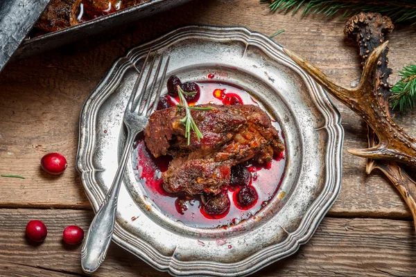 Healthy venison with cranberries and rosemary served on an old m — Stock Photo, Image