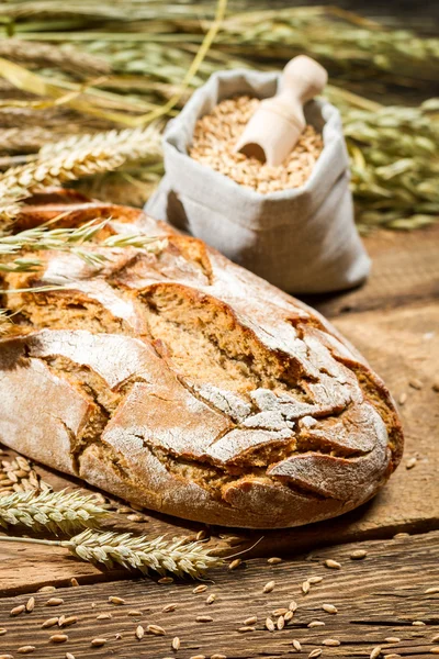 Healthy bread and a bag with grains — Stock Photo, Image