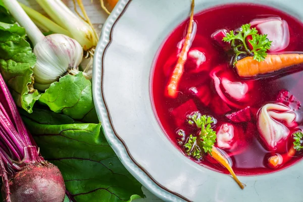 Beetroot soup with fresh vegetables on field — Stock Photo, Image