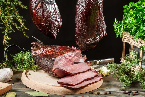 Freshly smoked ham in a rural smokehouse — Stock Photo, Image