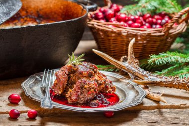 Venison with cranberry sauce in the forester clipart
