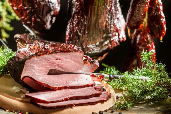 Closeup of freshly smoked ham in a rural smokehouse — Stock Photo, Image