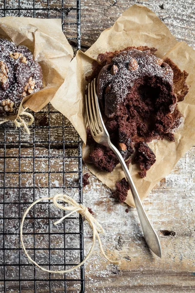 Closeup of tasting chocolate muffins with nuts — Stock Photo, Image