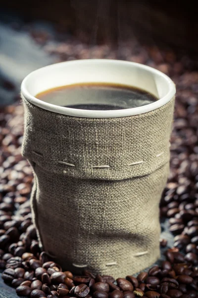 Freshly hot coffee in burlap sack — Stock Photo, Image