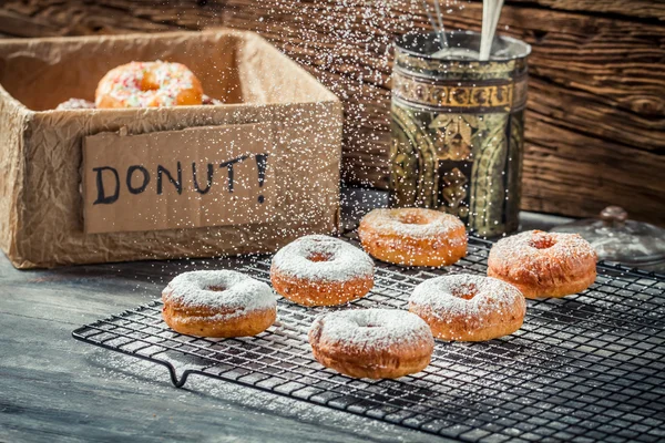 Closeup of falling powder sugar on donuts — Stock Photo, Image