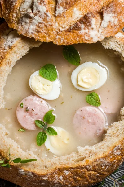 Closeup of sour soup in bread with marjoram — Stock Image Closeup of sour soup in bread with marjoram Stock Image