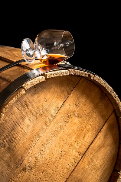 Glass of cognac on the old wooden barrel — Stock Photo, Image