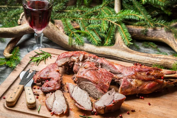 Fresh venison around with antlers and spruce — Stock Photo, Image