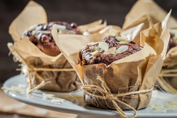 Plate full of chocolate muffins with almonds — Stock Photo, Image