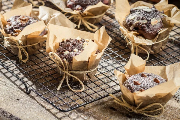 Muffins with icing sugar and almonds — Stock Photo, Image