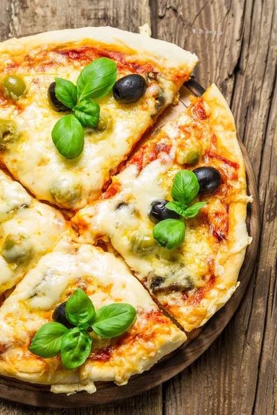 Nahaufnahme von frisch gebackener Pizza mit Käse und Basilikum — Stockfoto