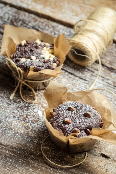 Closeup of decorating chocolate muffins — Stock Photo, Image