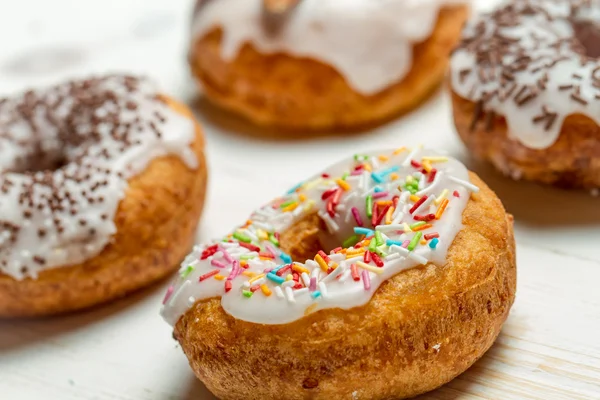 Freshly baked donuts with sprinkles — Stock Photo, Image