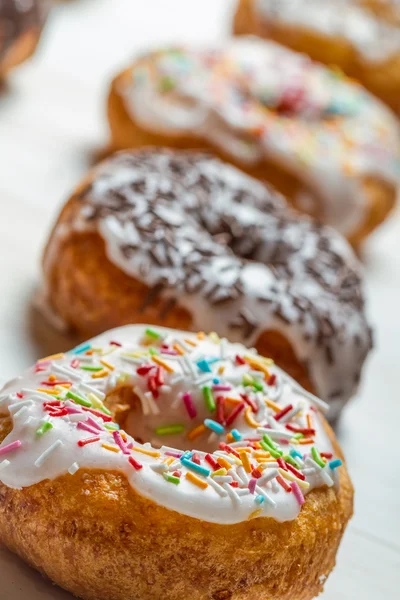 Closeup of freshly baked colorful donuts — Stock Photo, Image